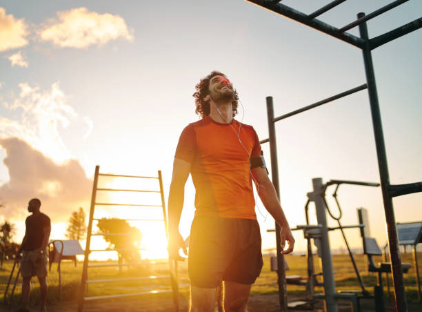 Rear view of a young male bodybuilder doing heavy weight exercise with  dumbbells against … | Male fitness photography, Fitness photoshoot,  Bodybuilding photography