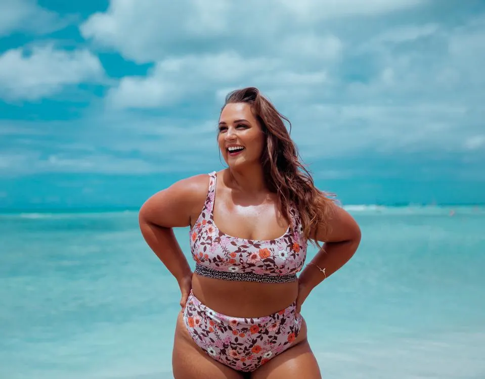 Beautiful African American female model posing on beach in swimsuit at  sunrise (sun rising behind her over ocean) - turquoise colored bikini Stock  Photo | Adobe Stock